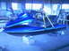 1994 Ford Bronco - A blue jet ski is seen suspended by yellow straps in what appears to be a workshop or garage setting.